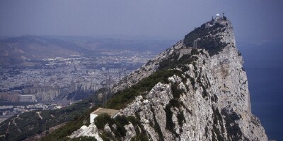 Gibraltar (GIB). The name of Gibraltar is derived from the Arabic Gibel T?riq � Tariq�s rock. It refers to Tariq ibn Ziyad, who was in charge of the force which landed in 711 on Gibraltar as a vanguard for the Moorish invasion of the Iberian Peninsula. The English captured Gibraltar from Spain in 1704. In 1830, Gibraltar officially became a British crown colony, and today it has a population of approximately 28,000.